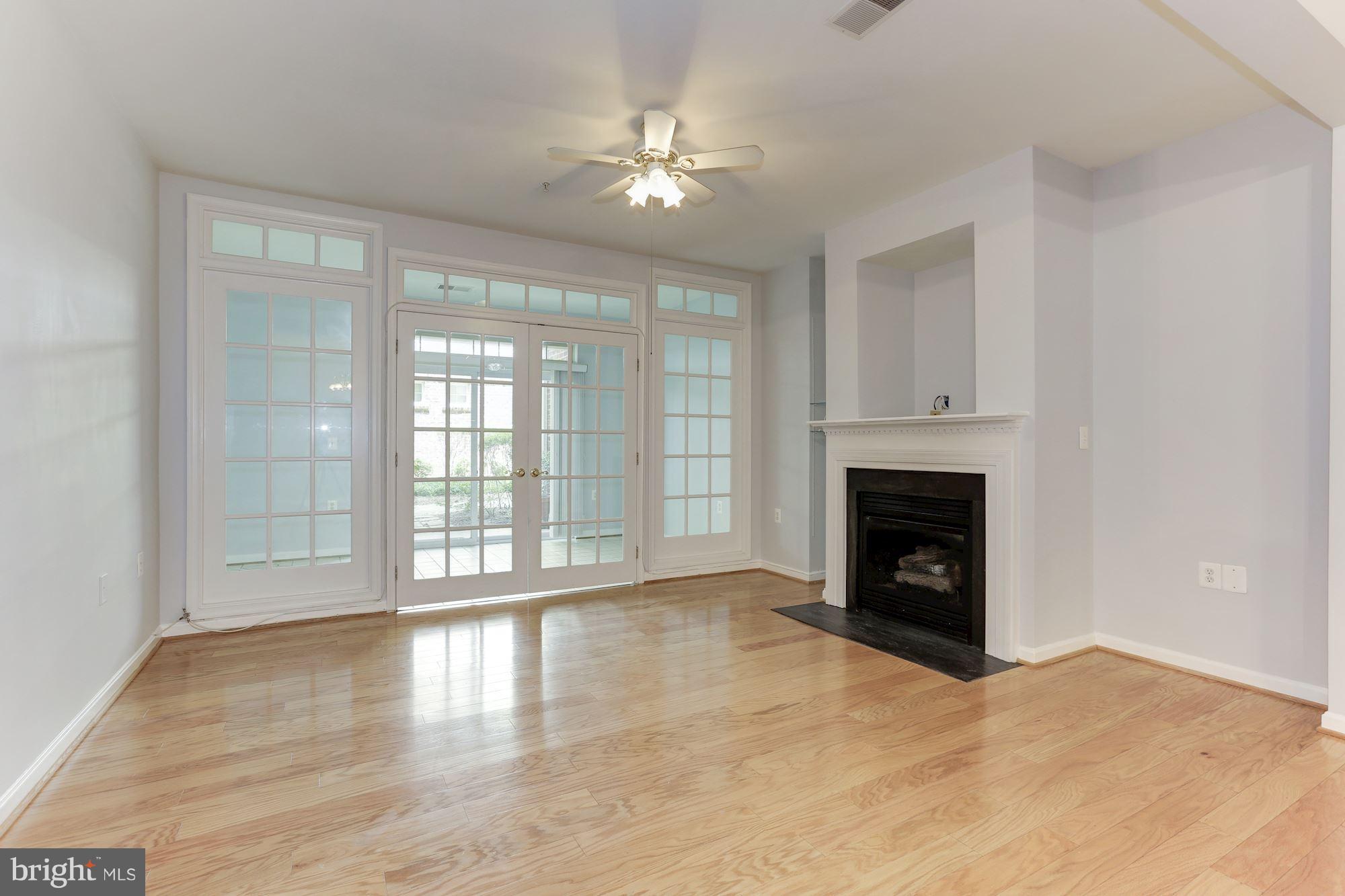 4330 Cannon Ridge Court, Unit 21 Fairfax, VA 22033 - Photo 13 of 24 a view of an empty room with a fireplace and a window