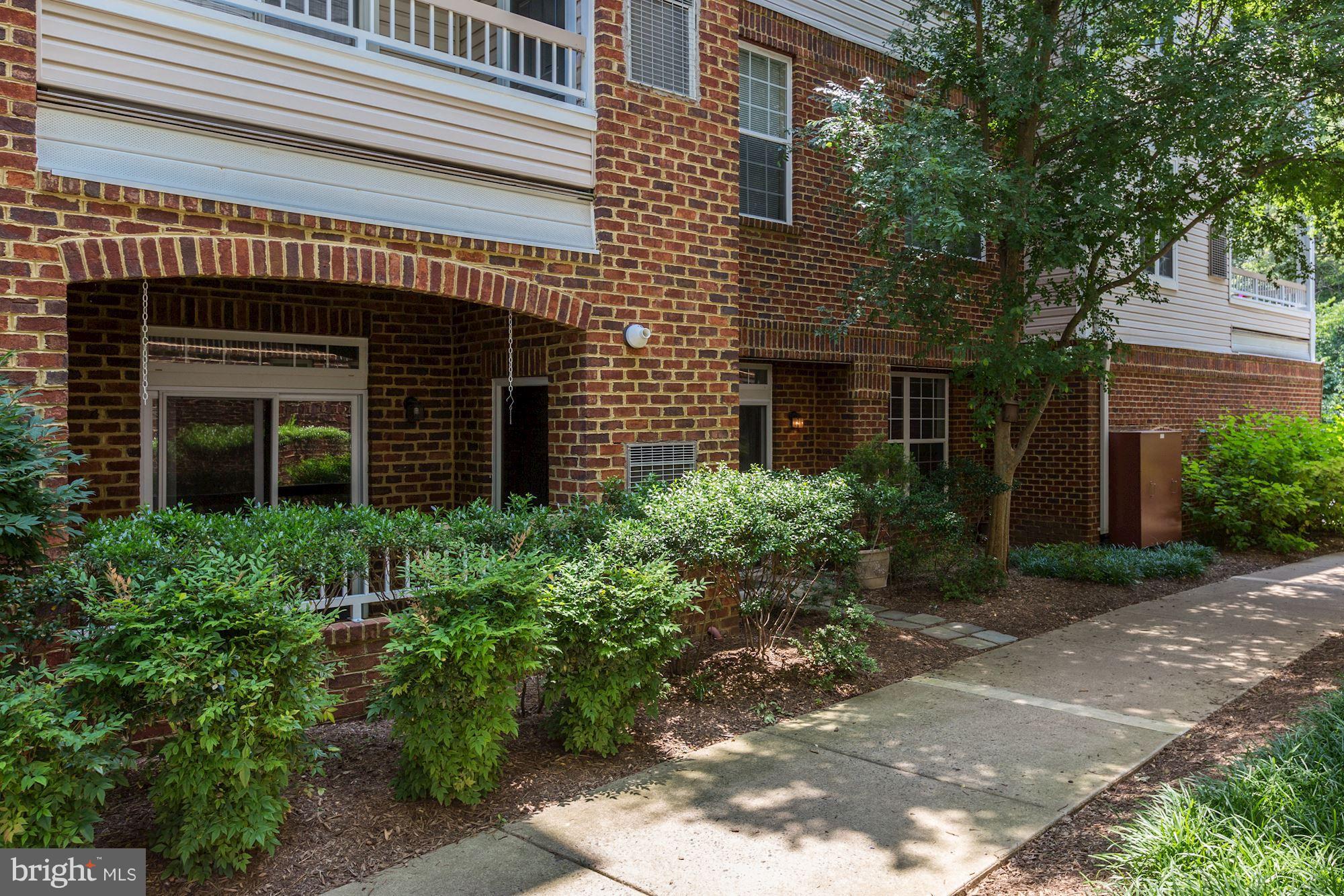 4330 Cannon Ridge Court, Unit 21 Fairfax, VA 22033 - Photo 17 of 24 a view of a house with plants and large windows