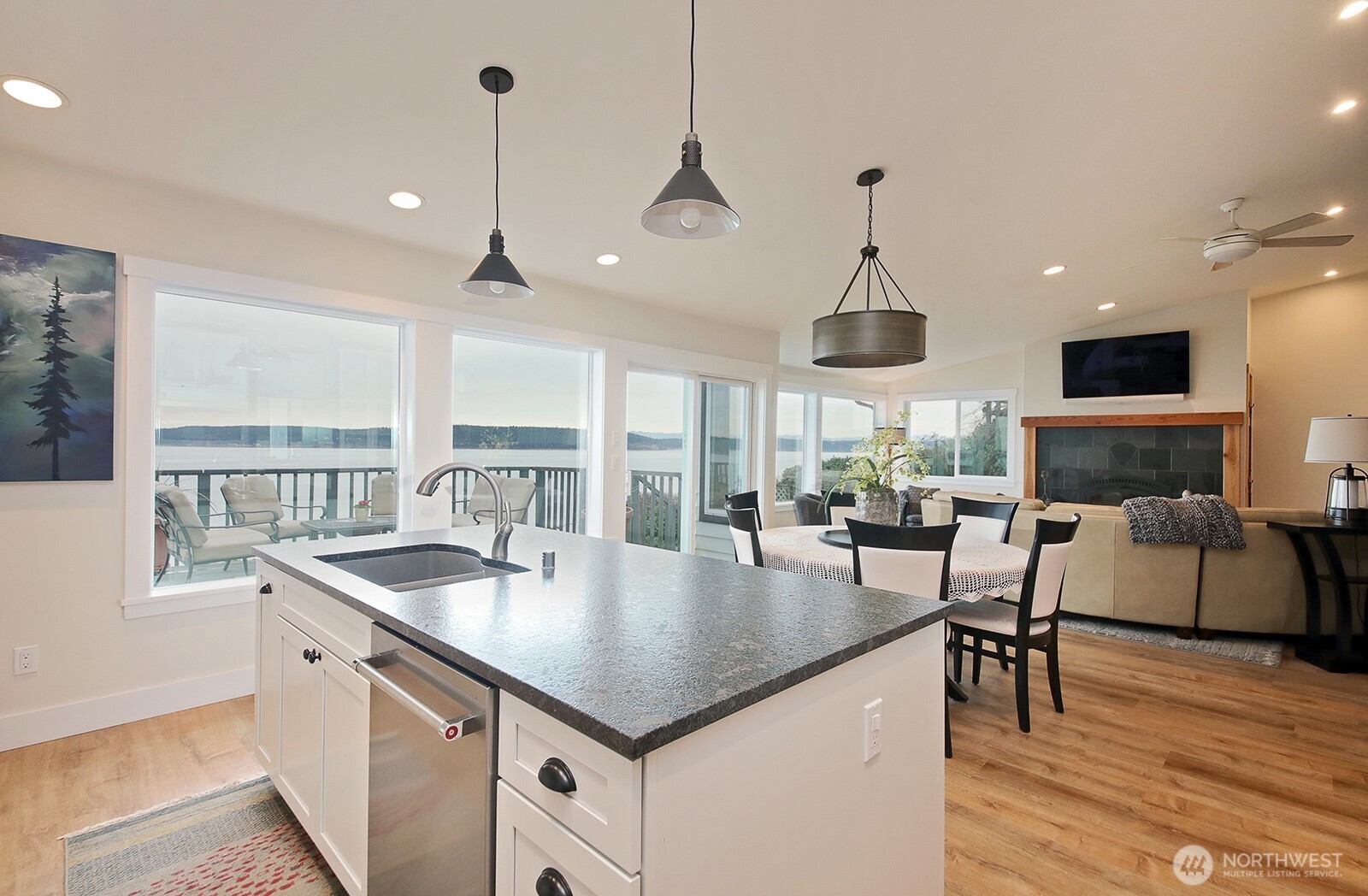 2999 Saratoga Road Langley, WA 98260 - Photo 11 of 40 a kitchen with center island wooden floor center island and windows