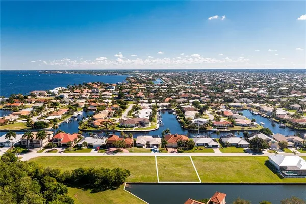 an aerial view of a residential building with outdoor space swimming pool and ocean view