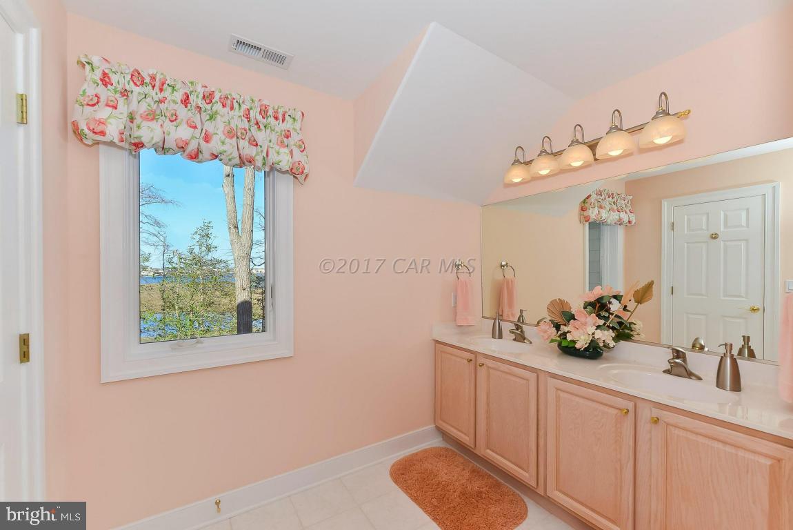 253 Charleston Road Ocean Pines, MD 21811 - Photo 50 of 76 a bathroom with a sink mirror and window