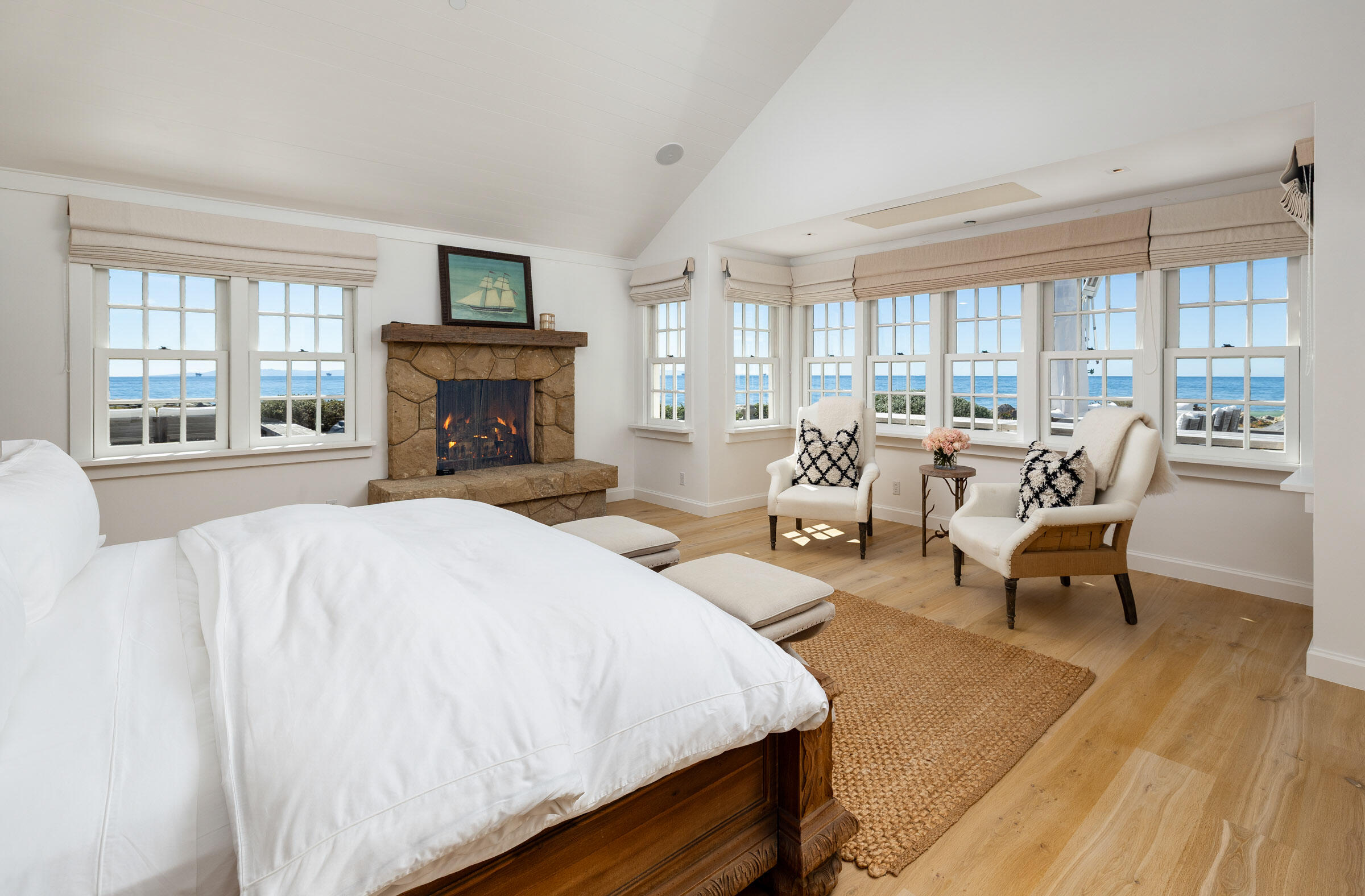 571 Sand Point Road Carpinteria, CA 93013 - Photo 22 of 49 a spacious bedroom with a bed and large windows