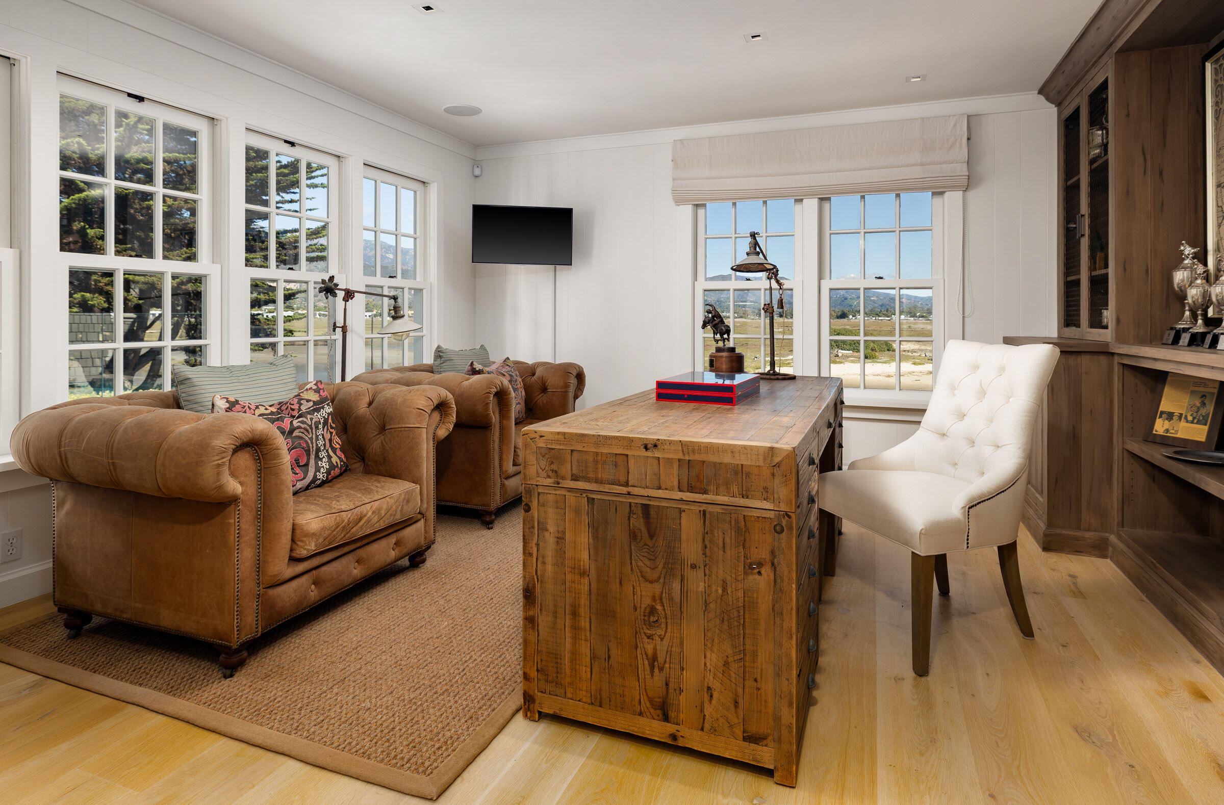 571 Sand Point Road Carpinteria, CA 93013 - Photo 34 of 49 a living room with furniture a flat screen tv and a floor to ceiling window