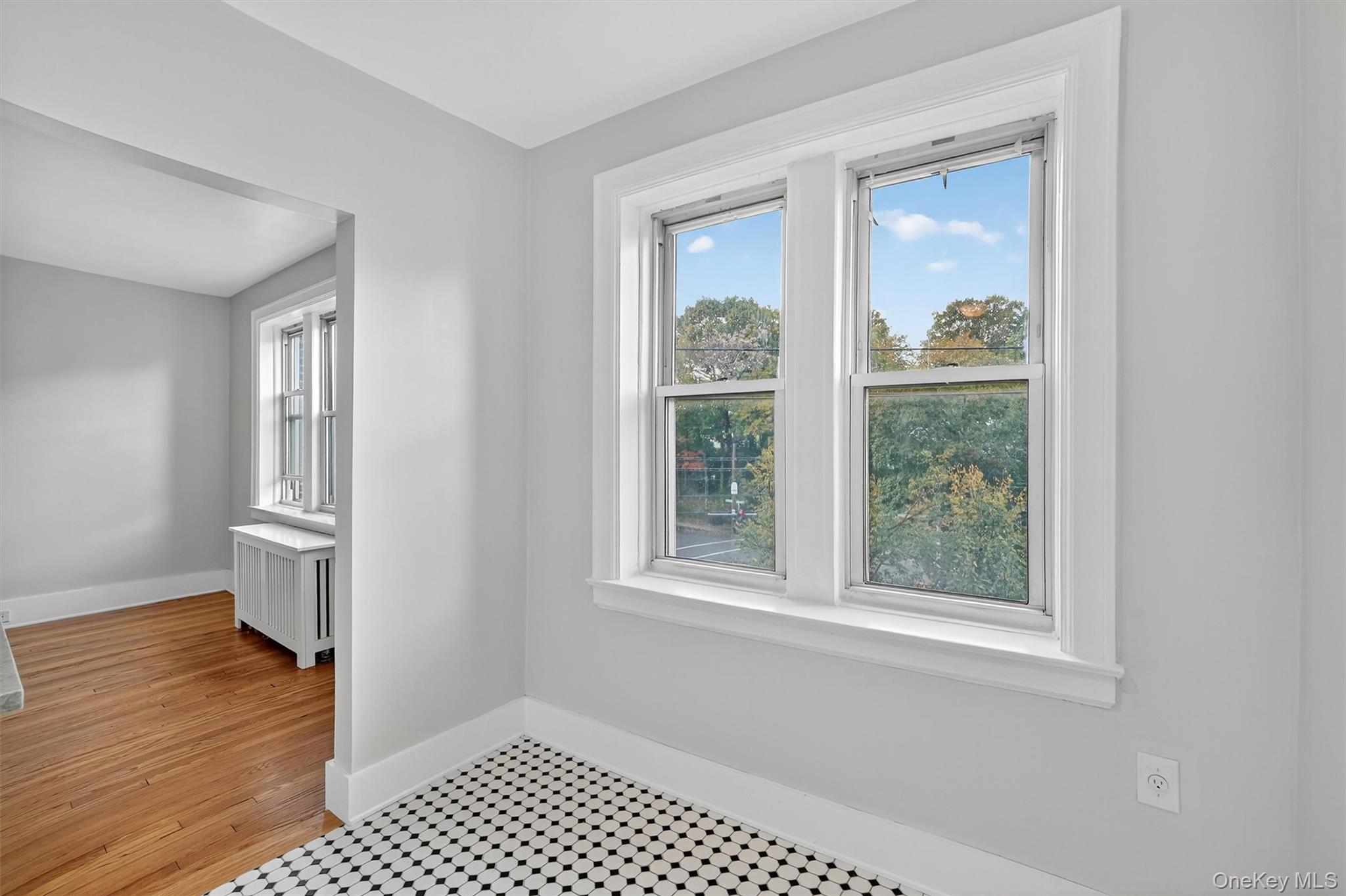 294 Bronxville Road, Unit 4C Bronxville, NY 10708 - Photo 15 of 26 a view of an empty room with wooden floor and a window