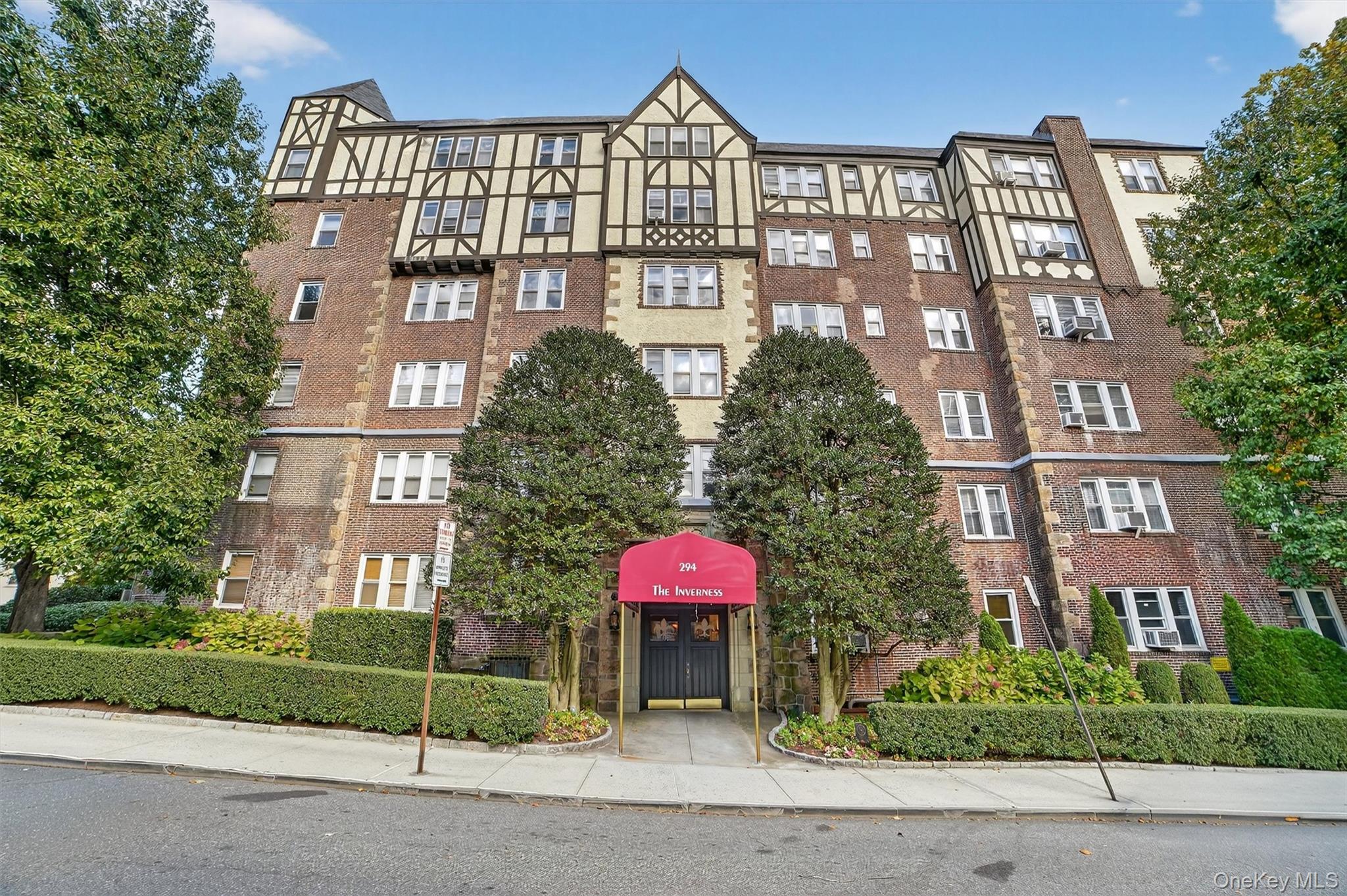 294 Bronxville Road, Unit 4C Bronxville, NY 10708 - Photo 2 of 26 a front view of a multi story building with yard