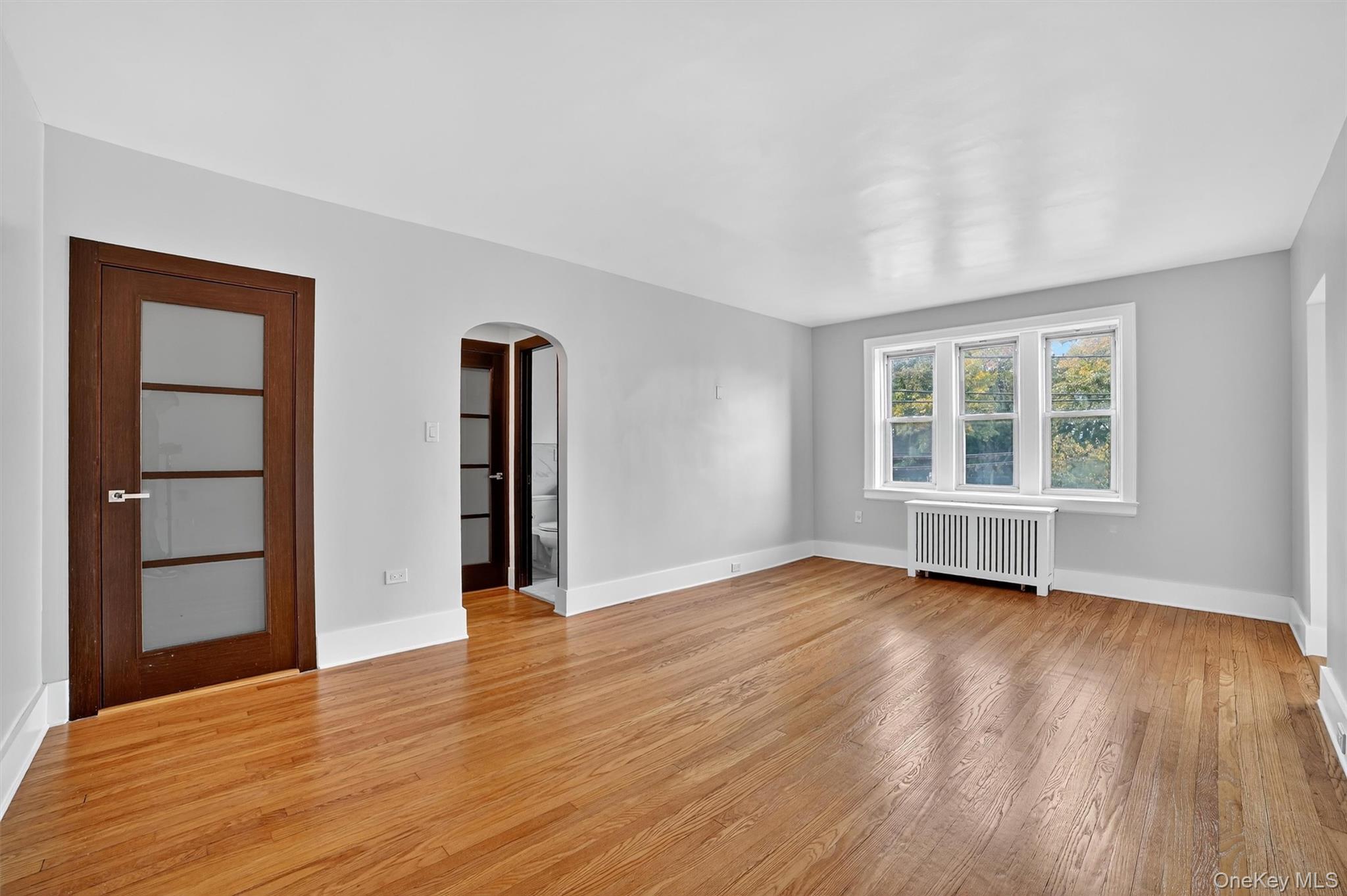 294 Bronxville Road, Unit 4C Bronxville, NY 10708 - Photo 23 of 26 a view of an empty room with wooden floor and windows