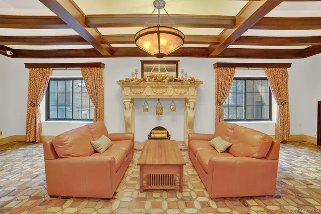 a living room with furniture a fireplace and a rug