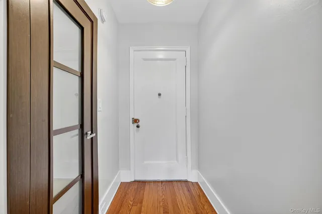 a view of a hallway with wooden floor