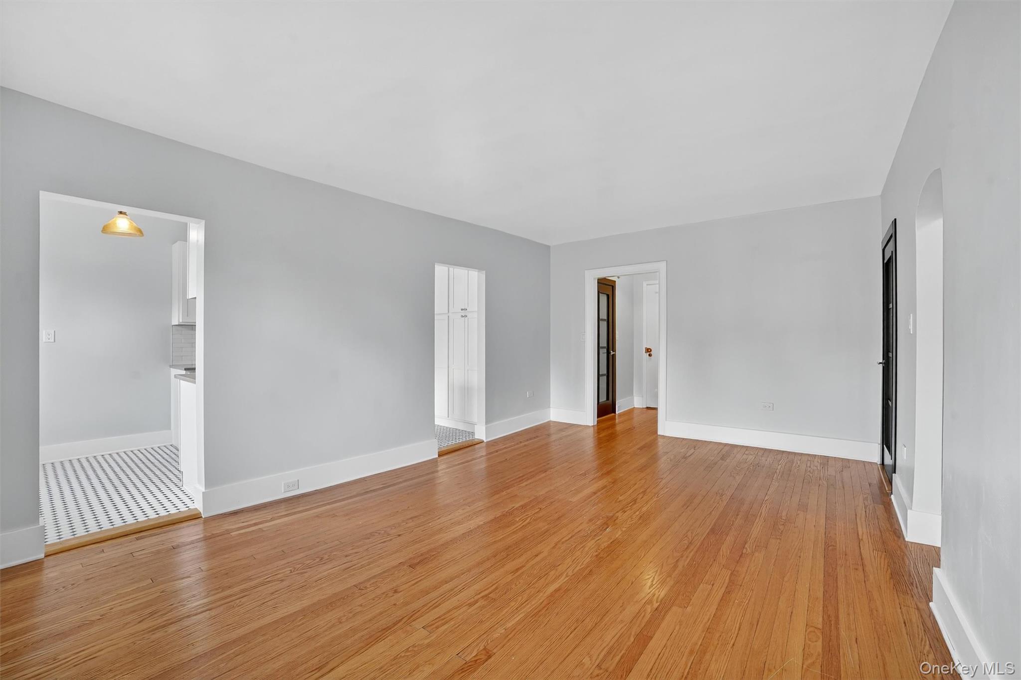 294 Bronxville Road, Unit 4C Bronxville, NY 10708 - Photo 7 of 26 a view of an empty room with wooden floor and a window