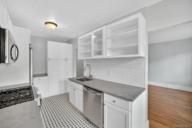 a kitchen with a sink and a stove top oven