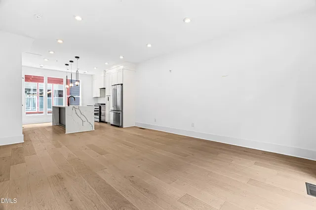 a view of kitchen with refrigerator and window