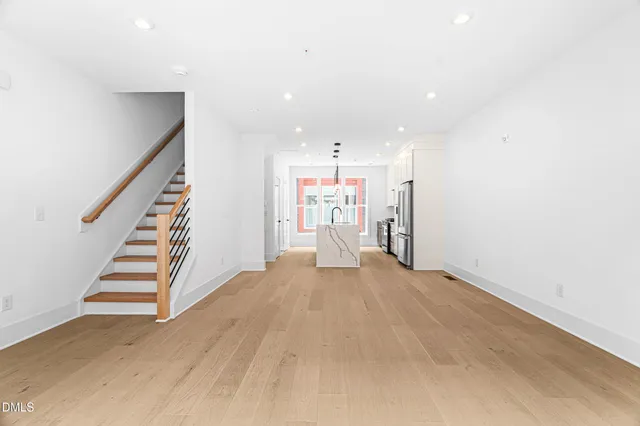 a view of a kitchen with wooden floor and stairs