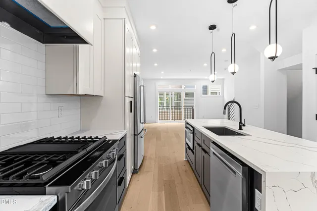a kitchen with a sink and a stove top oven