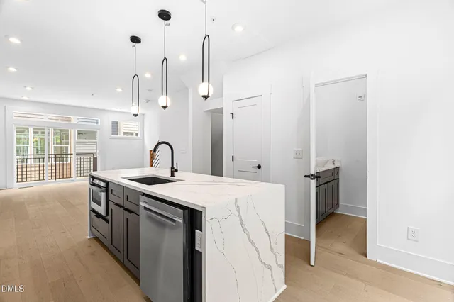 a kitchen with a sink and a stove top oven