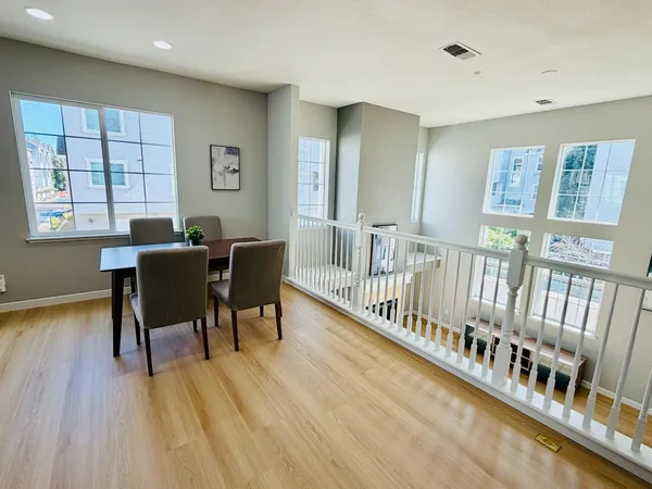 a view of a dining room with furniture window and wooden floor