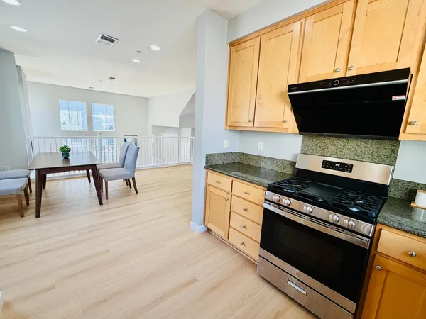 a kitchen with stainless steel appliances a stove a microwave and cabinets