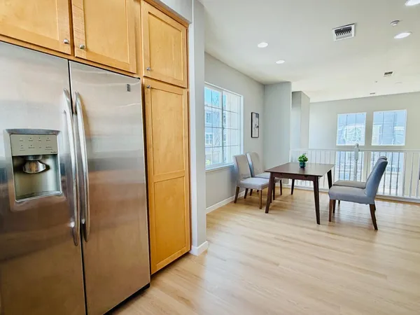 a view of a hallway with furniture and a window
