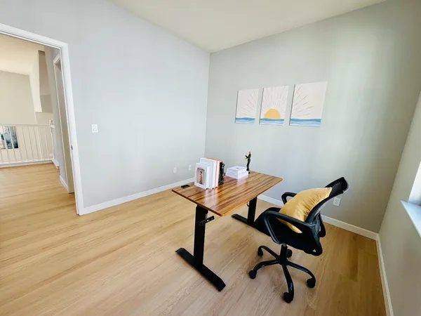 a workspace with furniture and wooden floor