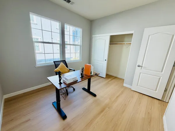 a living room with furniture and a wooden floor