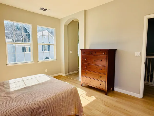 a bedroom with a bed and a dresser