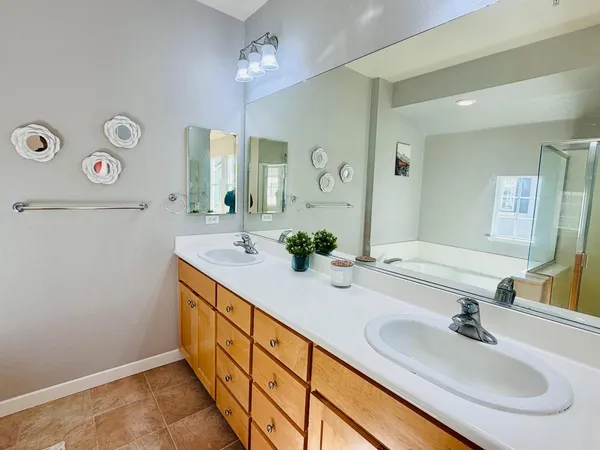 a bathroom with a double vanity sink and a mirror