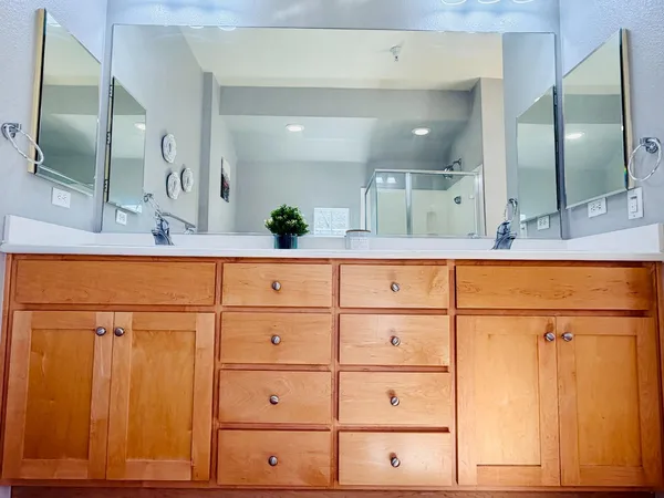 a bathroom with a sink a vanity and a large mirror