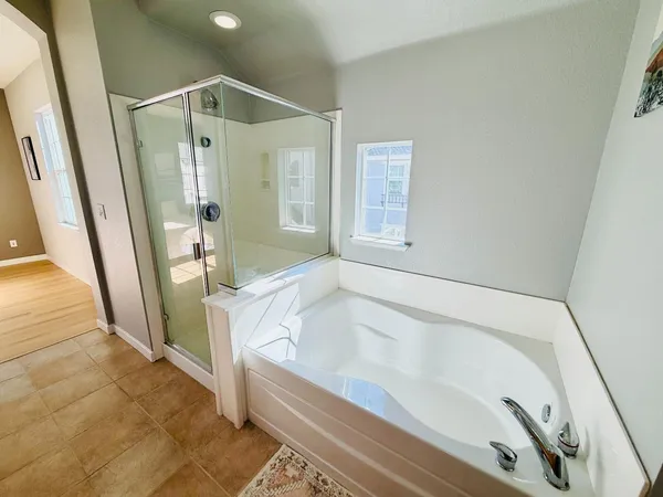 a bathroom with bathtub and a shower