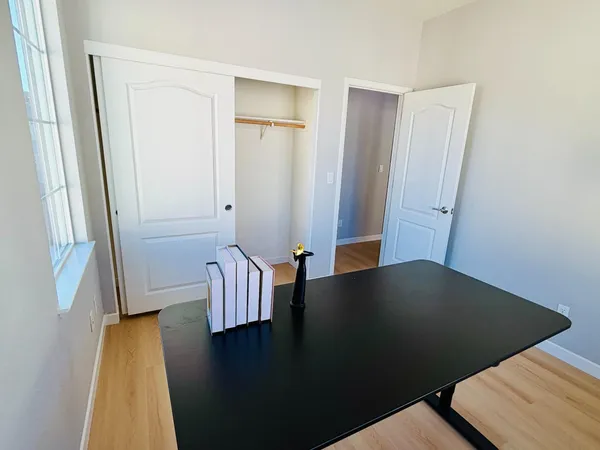 a view of a workspace with furniture and a window