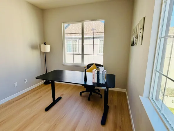 a workspace with furniture and a window