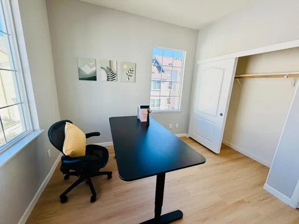 a bedroom with a bed and a window