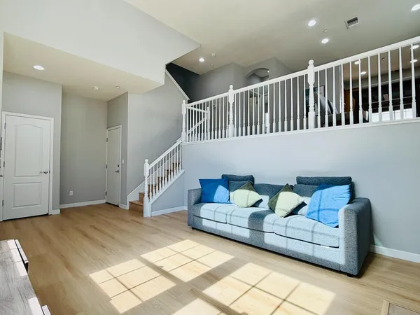 a living room with furniture and stairs