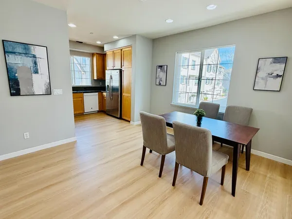 a view of a dining room with furniture window and wooden floor