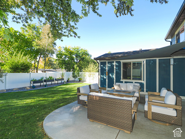 3308 Willow Ridge Road Salt Lake City, UT 84121 - Photo 10 of 59 Expansive backyard featuring a concrete patio, a manicured lawn, and raised garden beds