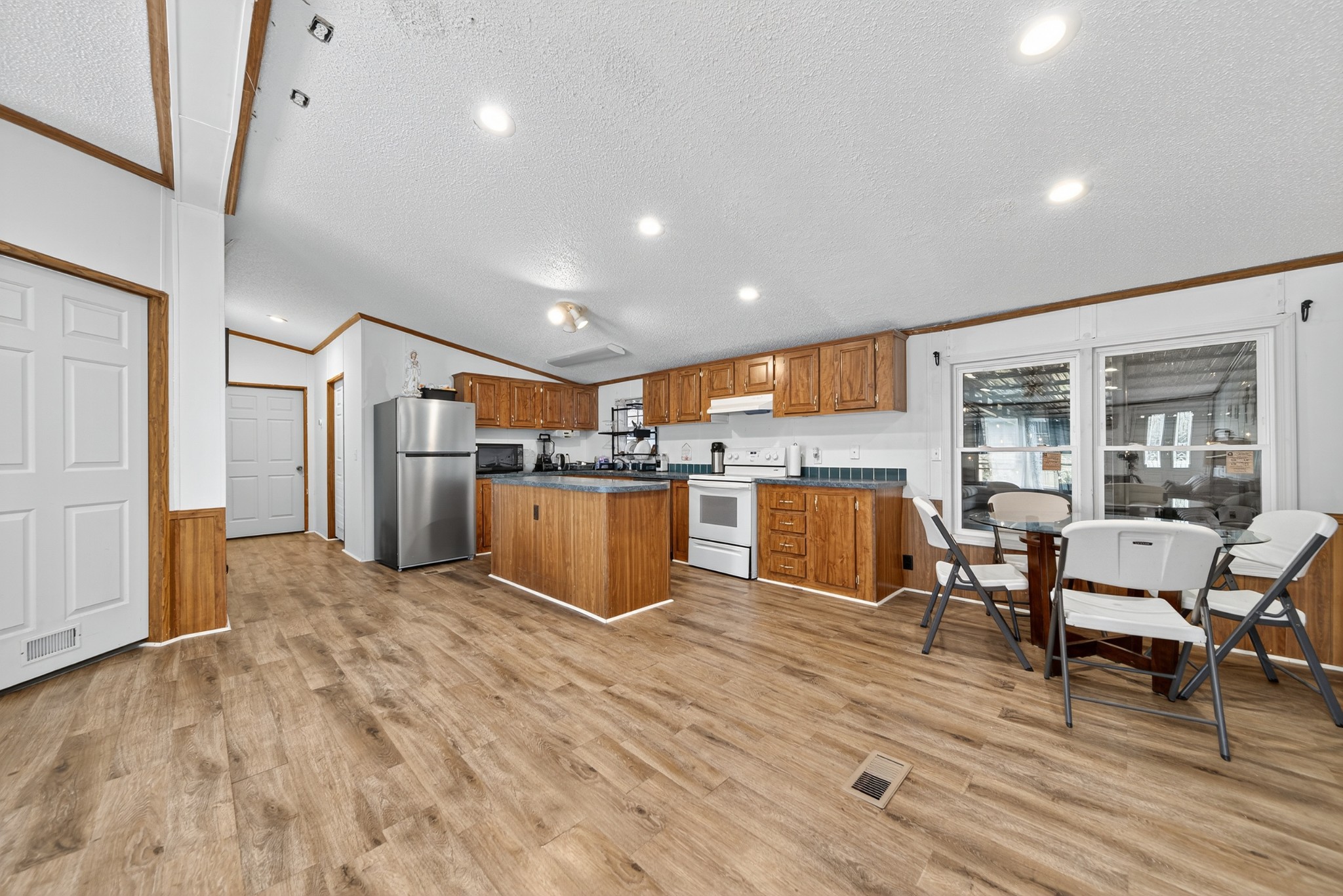 2600 Round Hill Road Lewisburg, TN 37091 - Photo 16 of 100 a kitchen with stainless steel appliances kitchen island granite countertop a refrigerator a stove top oven and a dining table with wooden floor