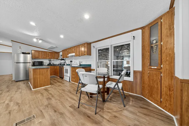 a bedroom with a bed lamp and a window