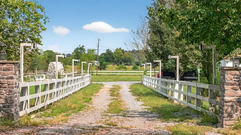 an aerial view of a house with a yard and lake view