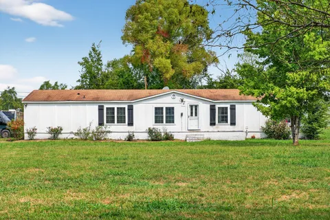 a kitchen with stainless steel appliances granite countertop a refrigerator stove microwave and sink