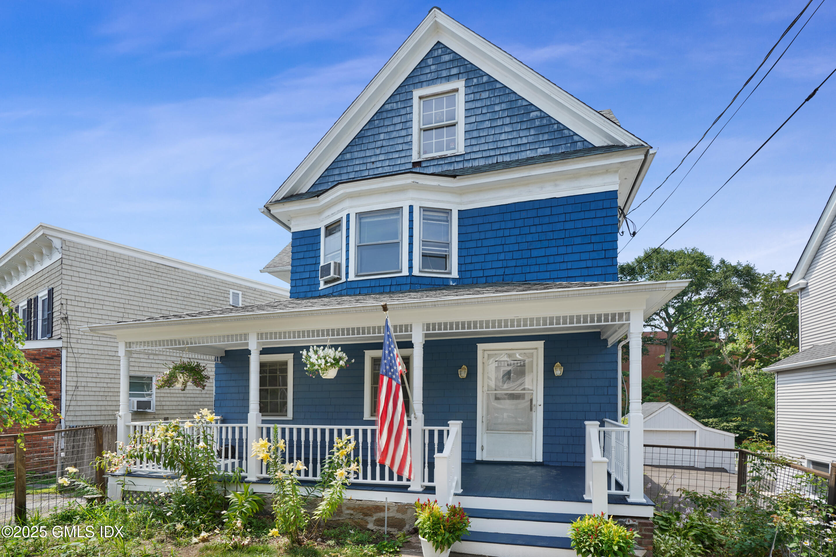 52 Locust Street Greenwich, CT 06830 - Photo 1 of 35 a front view of a house with garden