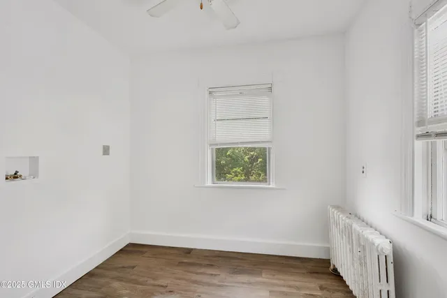 a view of room with window and wooden floor