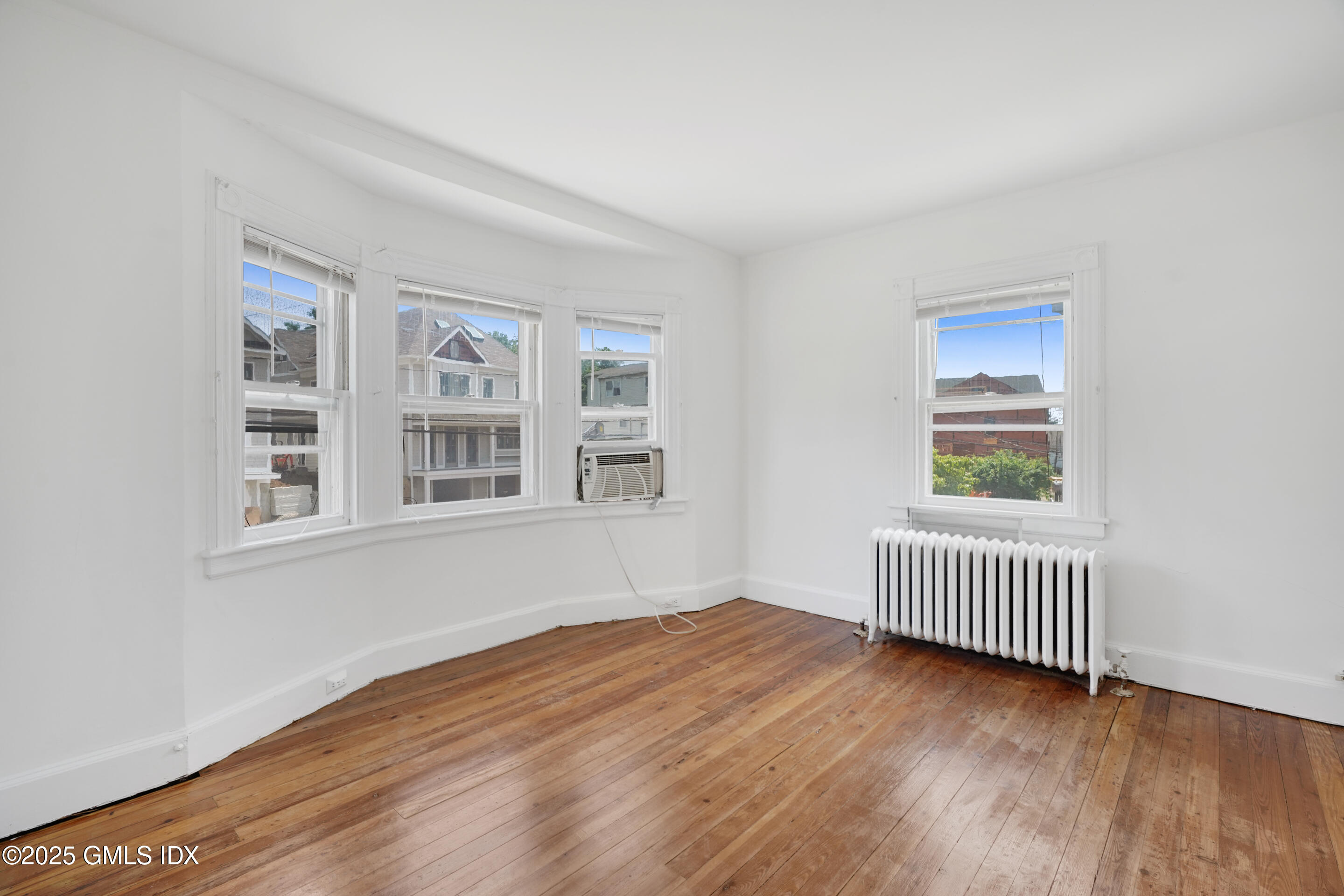 52 Locust Street Greenwich, CT 06830 - Photo 17 of 35 a view of empty room with wooden floor and fan