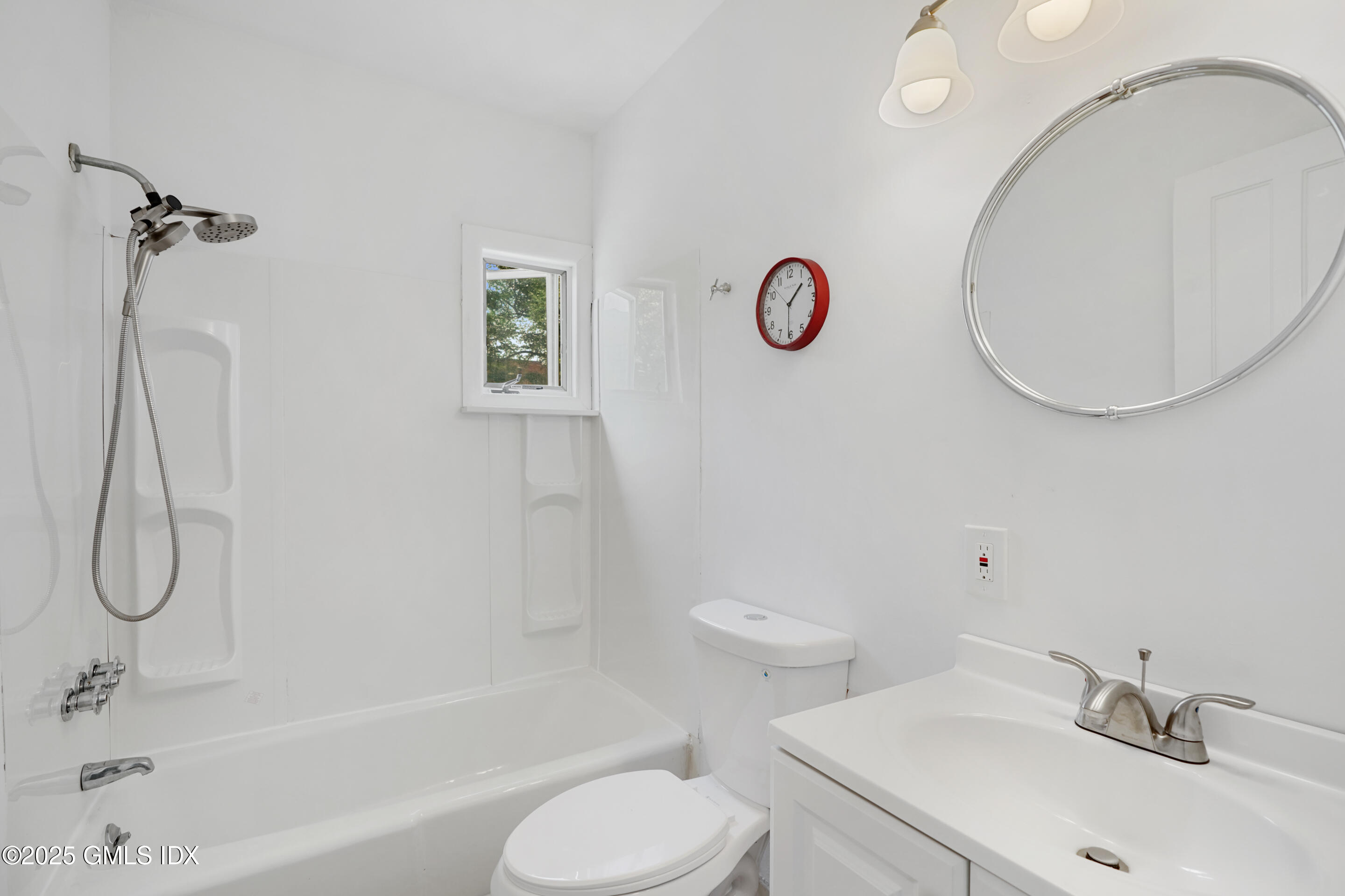 52 Locust Street Greenwich, CT 06830 - Photo 18 of 35 a bathroom with a sink and a mirror