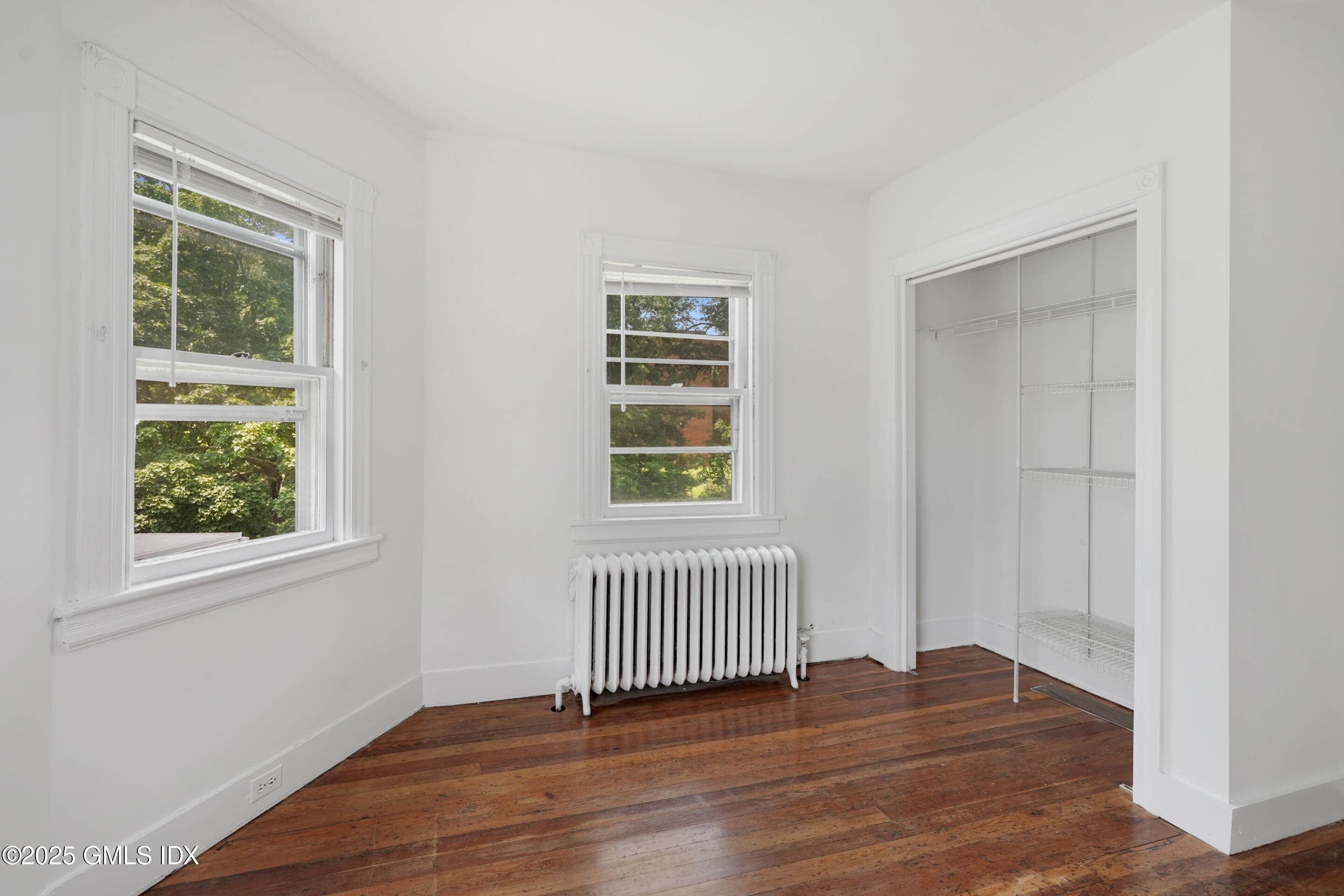 52 Locust Street Greenwich, CT 06830 - Photo 20 of 35 an empty room with wooden floor and windows
