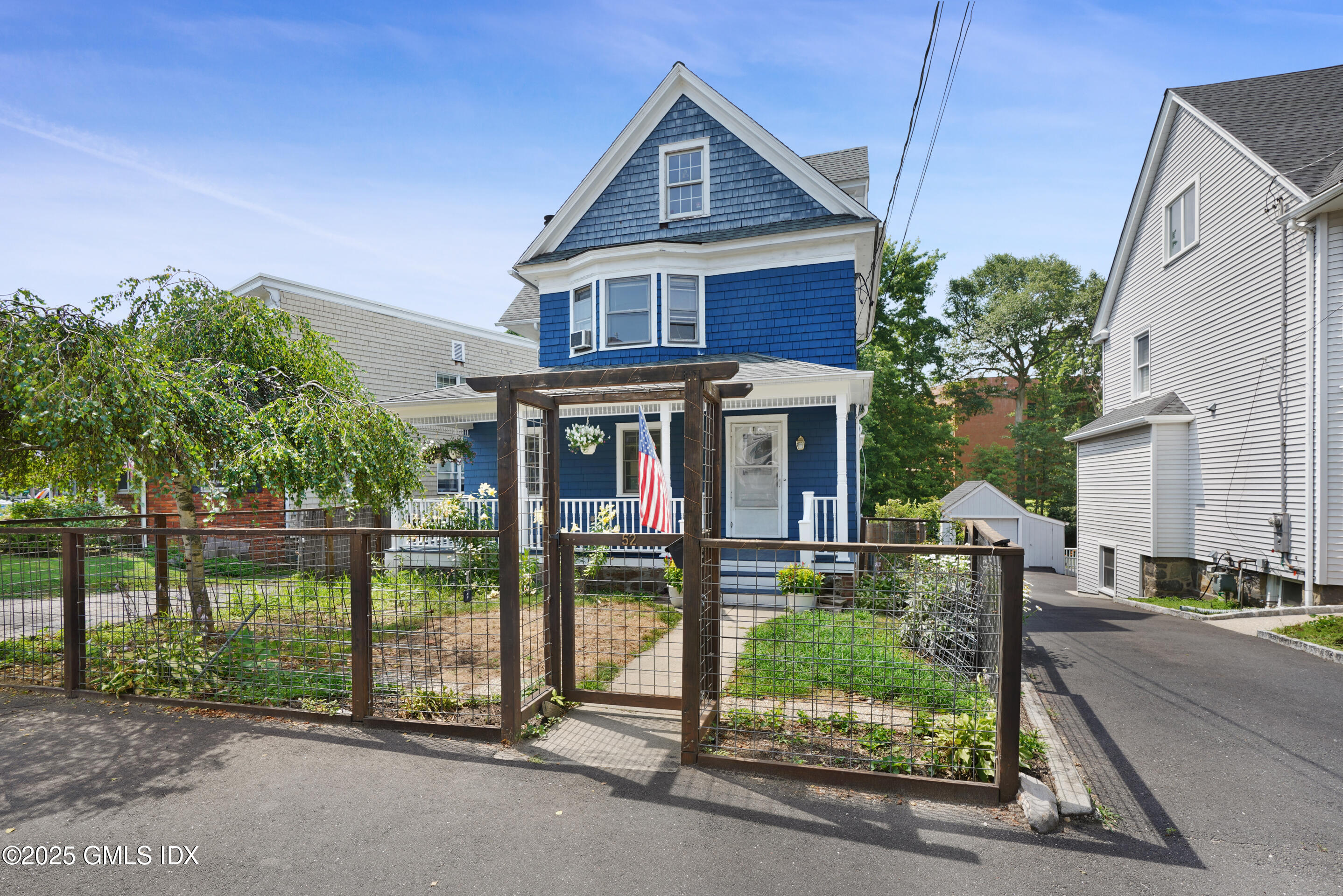 52 Locust Street Greenwich, CT 06830 - Photo 2 of 35 a front view of a house with garden
