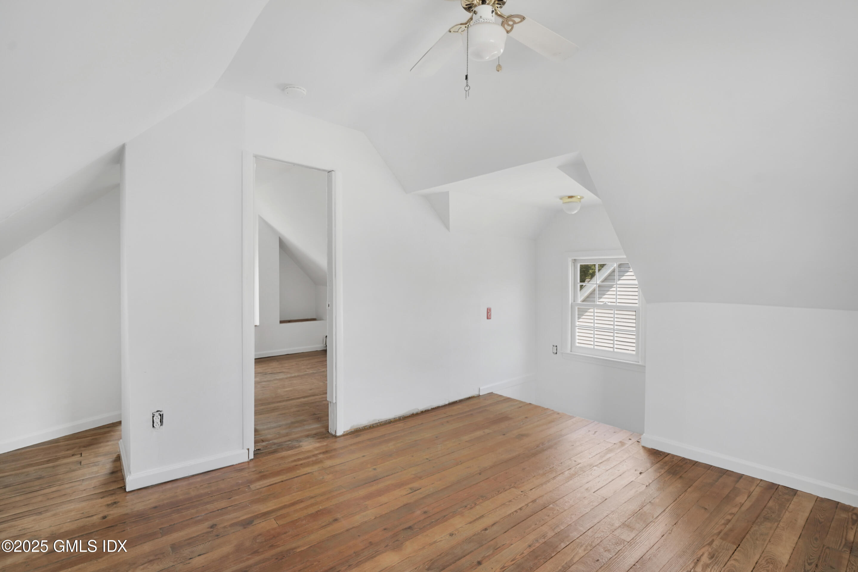 52 Locust Street Greenwich, CT 06830 - Photo 23 of 35 an empty room with wooden floor and windows