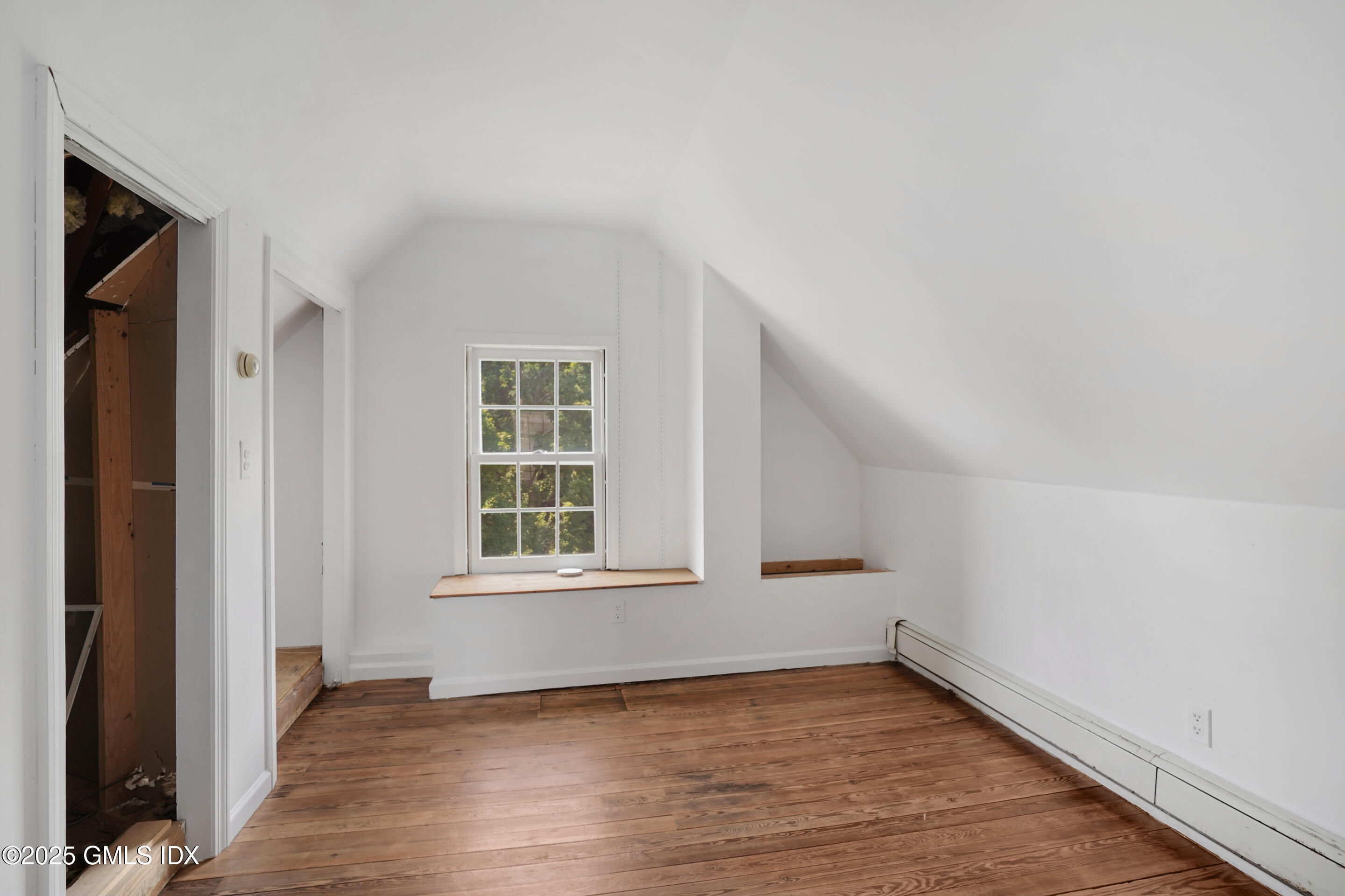 52 Locust Street Greenwich, CT 06830 - Photo 24 of 35 an empty room with wooden floor and windows