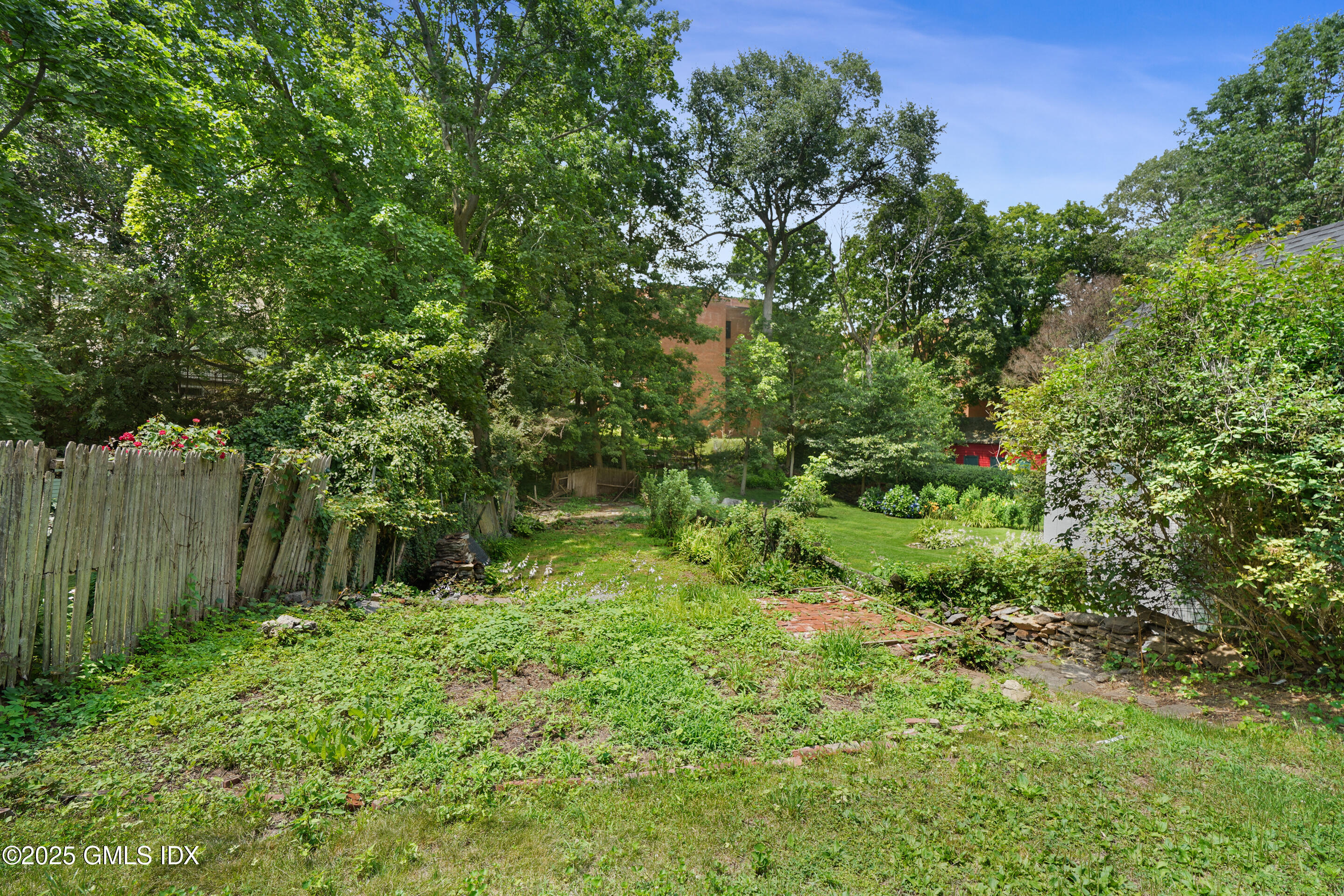 52 Locust Street Greenwich, CT 06830 - Photo 29 of 35 a backyard of a house with lots of green space
