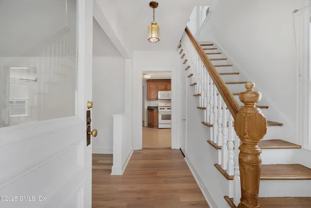 a view of entryway and hall with wooden floor