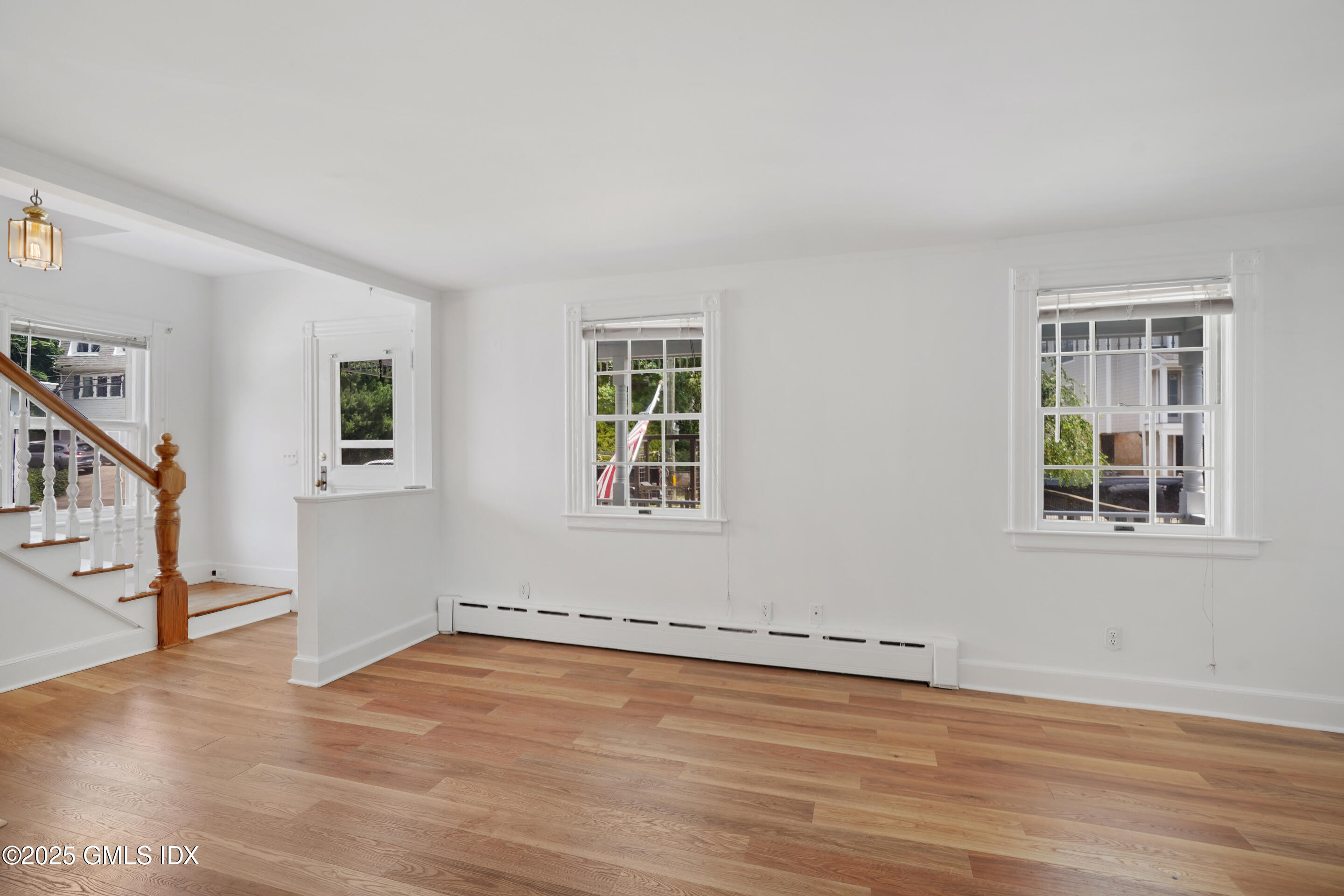 52 Locust Street Greenwich, CT 06830 - Photo 7 of 35 a view of an empty room with wooden floor and a window
