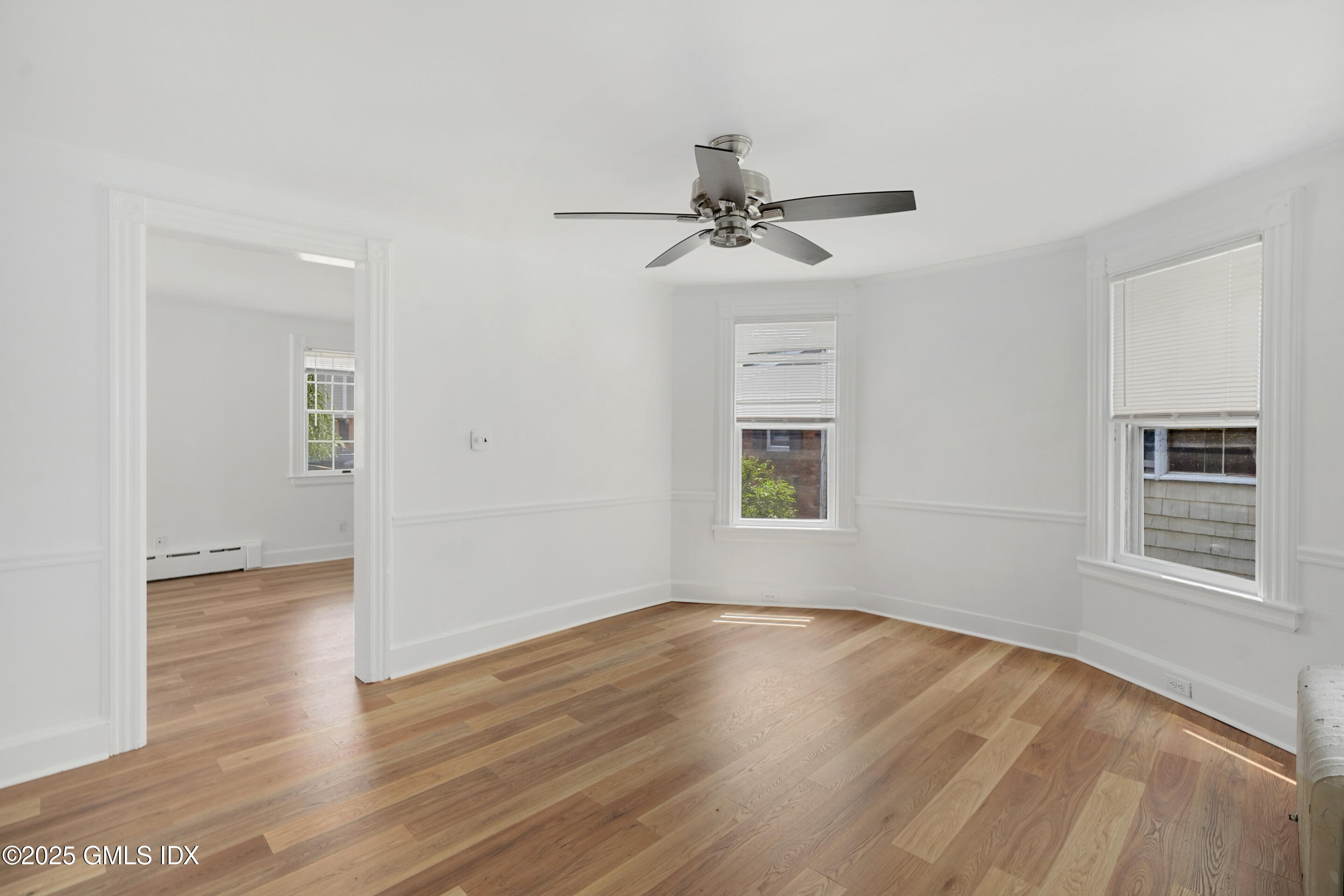 52 Locust Street Greenwich, CT 06830 - Photo 8 of 35 a view of empty room with wooden floor and fan