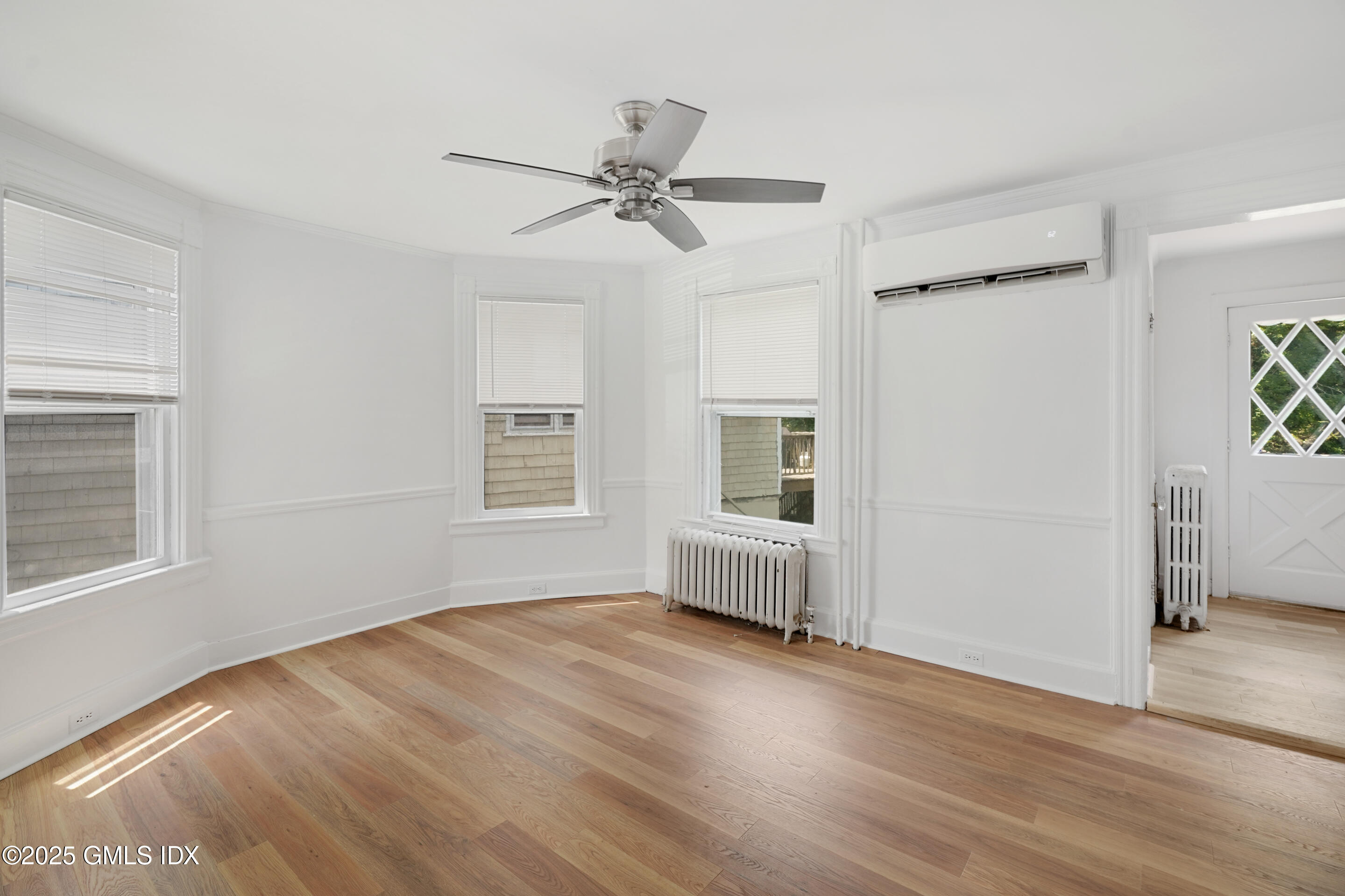 52 Locust Street Greenwich, CT 06830 - Photo 9 of 35 a view of empty room with wooden floor and fan